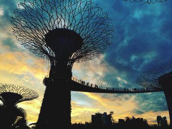 Low angle view of silhouette tree against dramatic sky