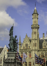 Low angle view of statue against cloudy sky