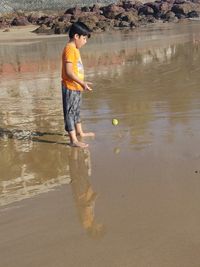 Boy standing at beach