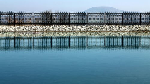 Metallic fence,blue lake,northern caucasus.