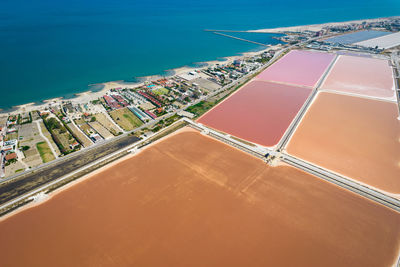 High angle view of swimming pool by building against sky