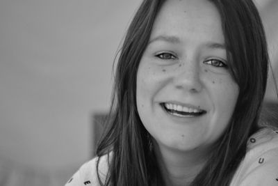 Close-up portrait of smiling young woman