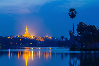 Reflection of trees and buildings in lake