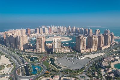 High angle view of cityscape against blue sky