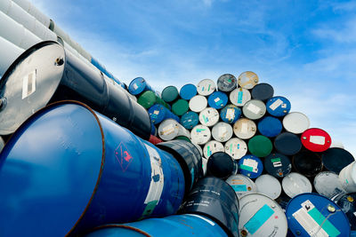 Low angle view of stack against blue sky