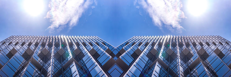 Low angle view of modern building against blue sky