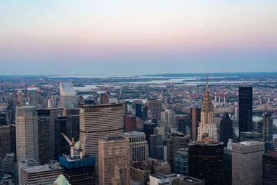 High angle view of city buildings against sky during sunset