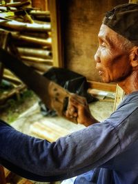 Side view of man working in workshop