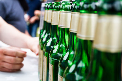 Close-up of beer bottles in row on table