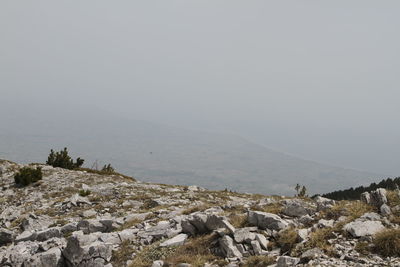 Scenic view of sea and mountains against clear sky