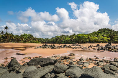 Ghana beach with rocks and sea meet from two sides and closed lagoon