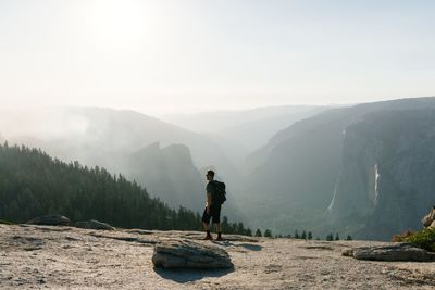 Man standing on mountain against clear sky