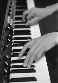 Midsection of man playing piano