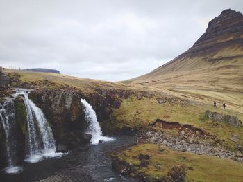 Scenic view of mountains against cloudy sky