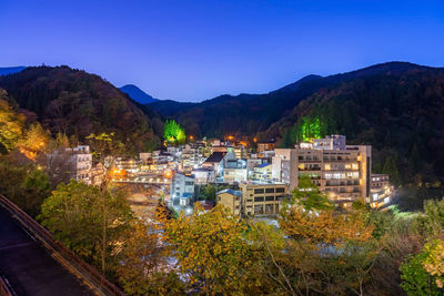 High angle view of buildings and mountains against clear sky