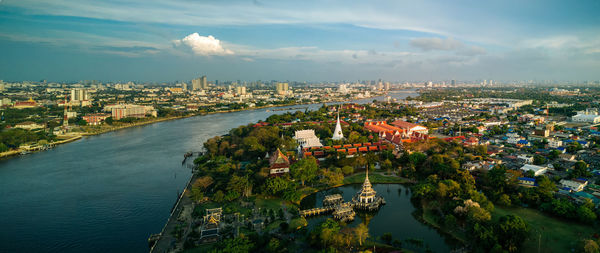 High angle view of river amidst cityscape against sky