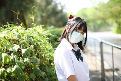 Portrait of young woman standing outdoors