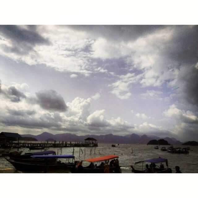 transfer print, sky, auto post production filter, built structure, water, architecture, cloud - sky, building exterior, cloudy, sea, cloud, large group of people, nature, outdoors, river, day, panoramic, beach, high angle view, travel destinations