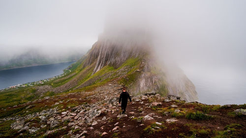 Rear view of man walking on mountain