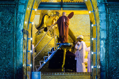 Rear view of people working in water