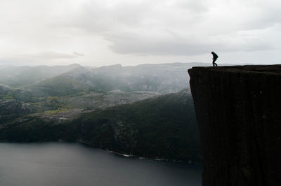 Man standing on mountain against sky