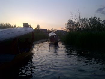 Scenic view of river against sky at sunset