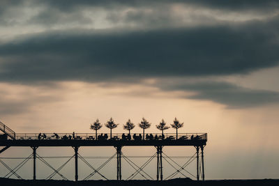 Pier against stormy sky