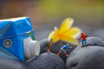 Close-up of yellow toys against blue sky