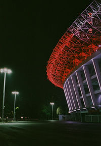 Low angle view of illuminated buildings against sky at night