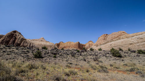 Scenic view of rocky mountains against clear blue sky