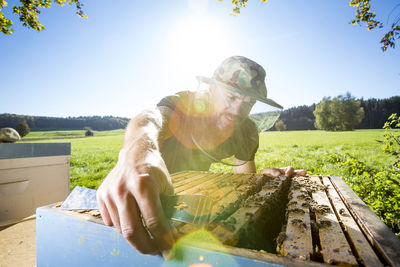 Portrait of woman on field during sunny day