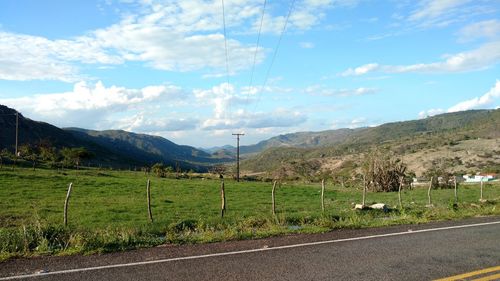 Scenic view of landscape against blue sky