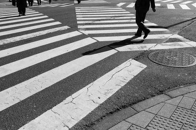 Low section of people walking on road