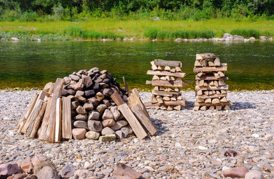 Stack of stones in lake at forest