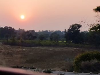 Scenic view of field against sky during sunset
