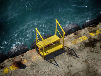 High angle view of yellow boat on sea shore