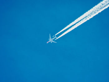 Low angle view of airplane flying in sky