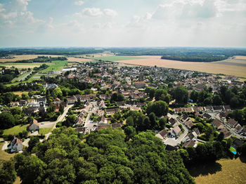 High angle view of townscape by sea against sky