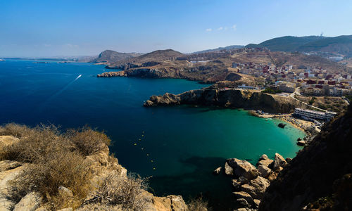 High angle view of sea and bay against sky