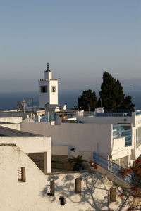 High angle view of building and trees against clear sky