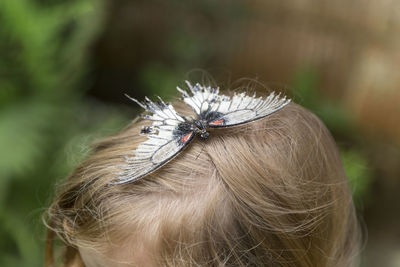 Close-up of butterfly on girl