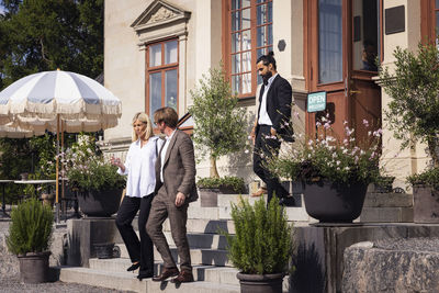 Business people leaving elegant restaurant