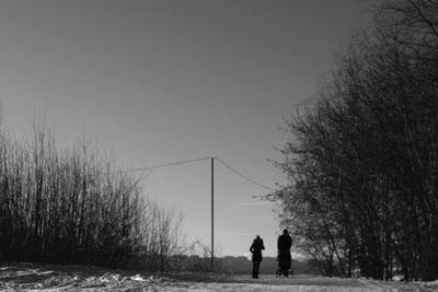 Woman standing on tree trunk