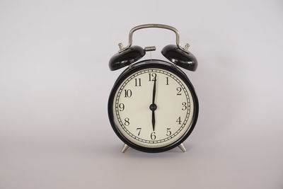 Close-up of alarm clock against white background