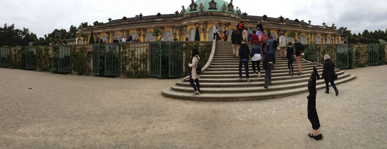 architecture, built structure, building exterior, sky, cloud - sky, travel destinations, steps, famous place, history, men, travel, tourism, day, architectural column, walking, cloud, person, incidental people, low angle view