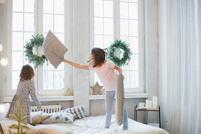 Woman standing by window at home