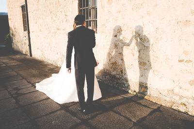 Shadow of married couple on wall