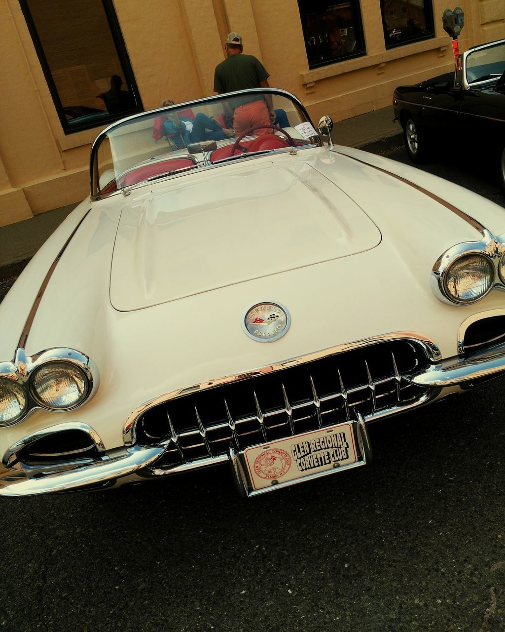 CLOSE-UP OF VINTAGE CAR ON THE ROAD