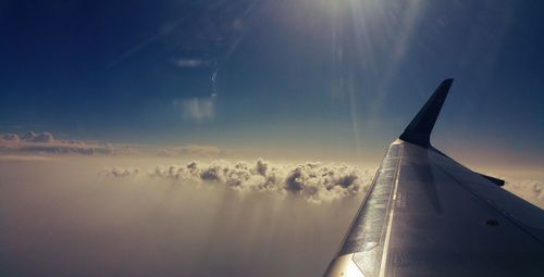 Close-up of airplane wing against sky