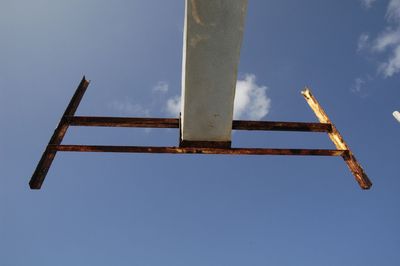 Low angle view of metal against blue sky